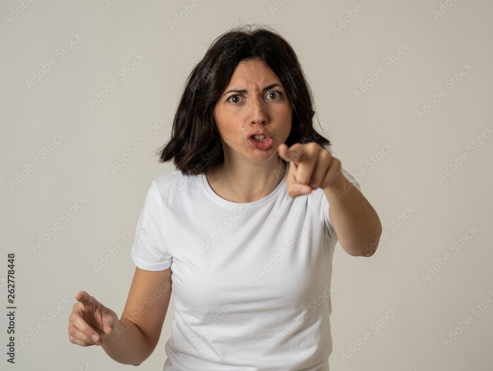 Portrait of a beautiful young woman with angry face looking furious. Human expressions and emotions Portrait of a beautiful young woman with angry face looking furious. Human expressions and emotions