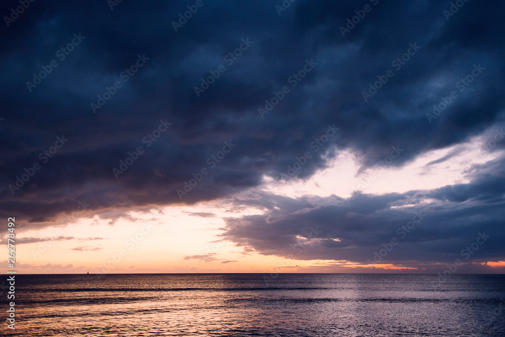 spectacular sunset on a beach with stormy sky