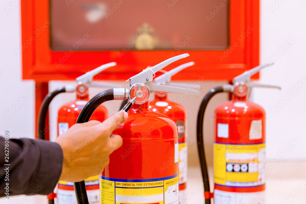 Male Professional inspection Fire extinguisher,safety concept.