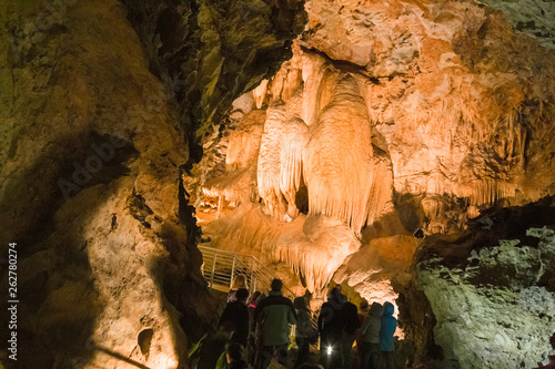 LEVIGLIANI, ITALY - JUNE 05, 2016: Some visitors admire the stalactites of the Antro del Monte Corchia cave in the Apuan Alps in Italy. photo