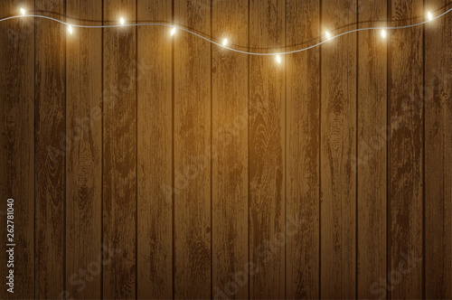 Garland with light bulbs hanging on a wooden wall