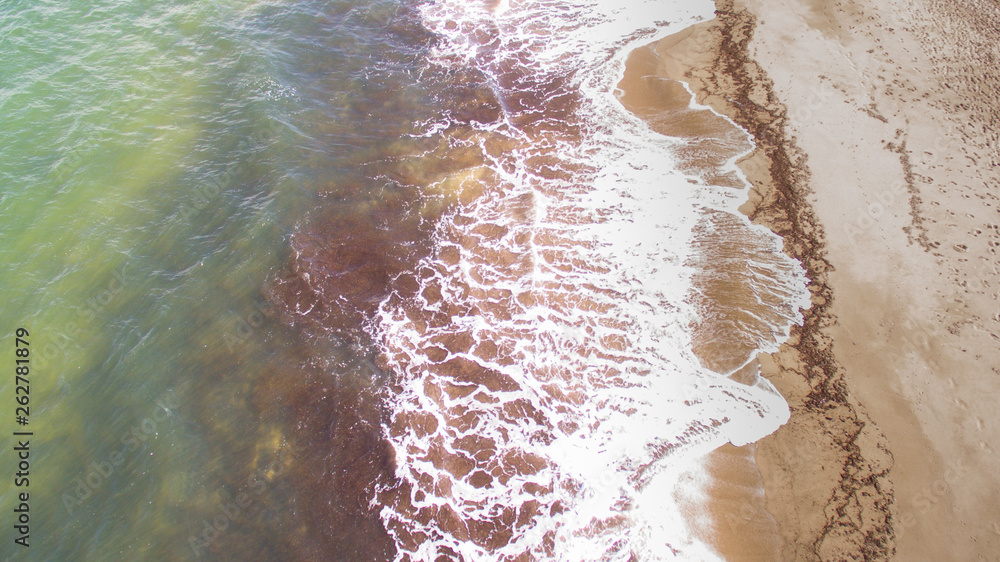 sea waves on the shoreline seen with the drone