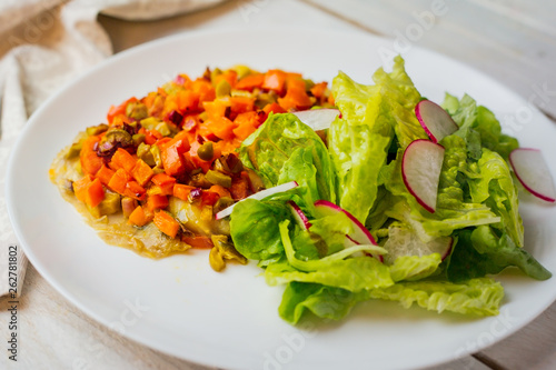 Baked vegetables with sauce and salad. Radish. Diet. Vegetarian. Homemade.