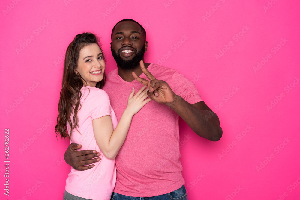 © Yakobchuk Olena - Waist up of smiling interracial couple looking at camera in studio © Yakobchuk Olena - Waist up of smiling interracial couple looking at camera in studio