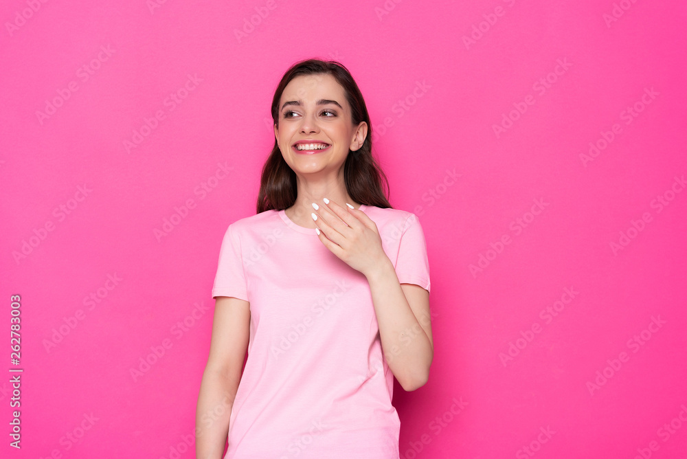 Low angle of happy brunette Caucasian girl posing for camera in studio Low angle of happy brunette Caucasian girl posing for camera in studio