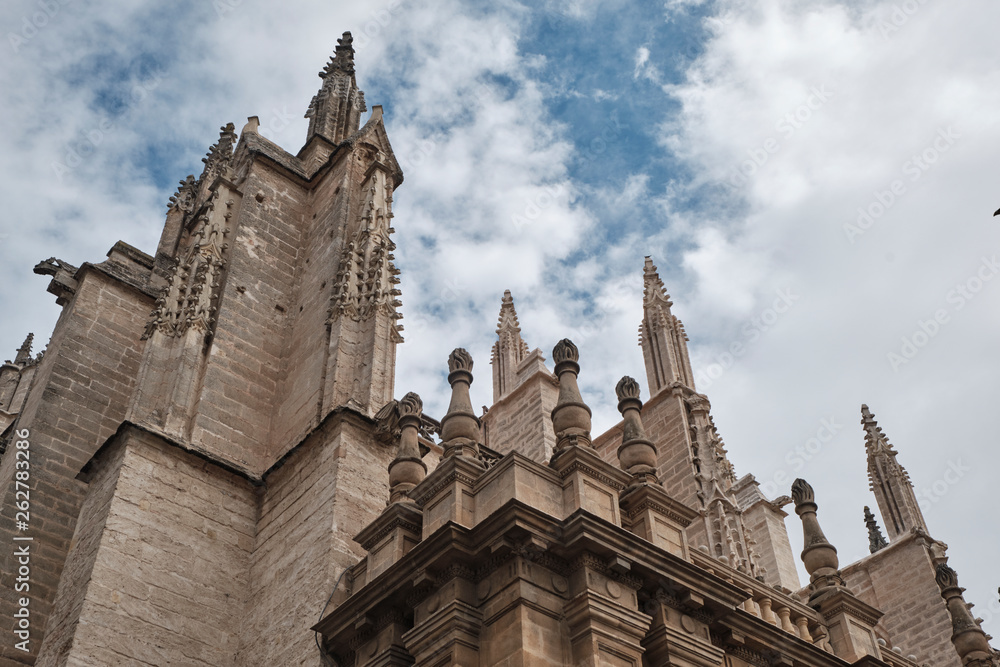 Cathedral of Saint Mary of the See (Seville Cathedral) in Seville, Andalusia, Spain in a sunny and cloudy day.