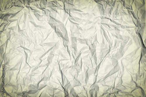 Crumpled gray paper. Blank background for layout with vignette. Paper texture closeup.