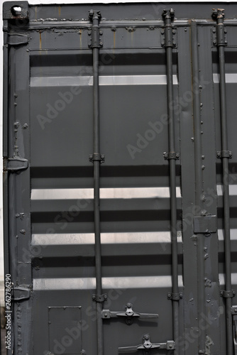 Details of grey cargo container door.