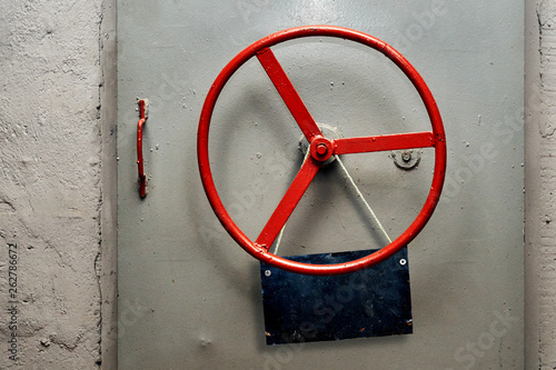 Empty warning sign plate hanging on a hermetic bomb shelter armored door photo