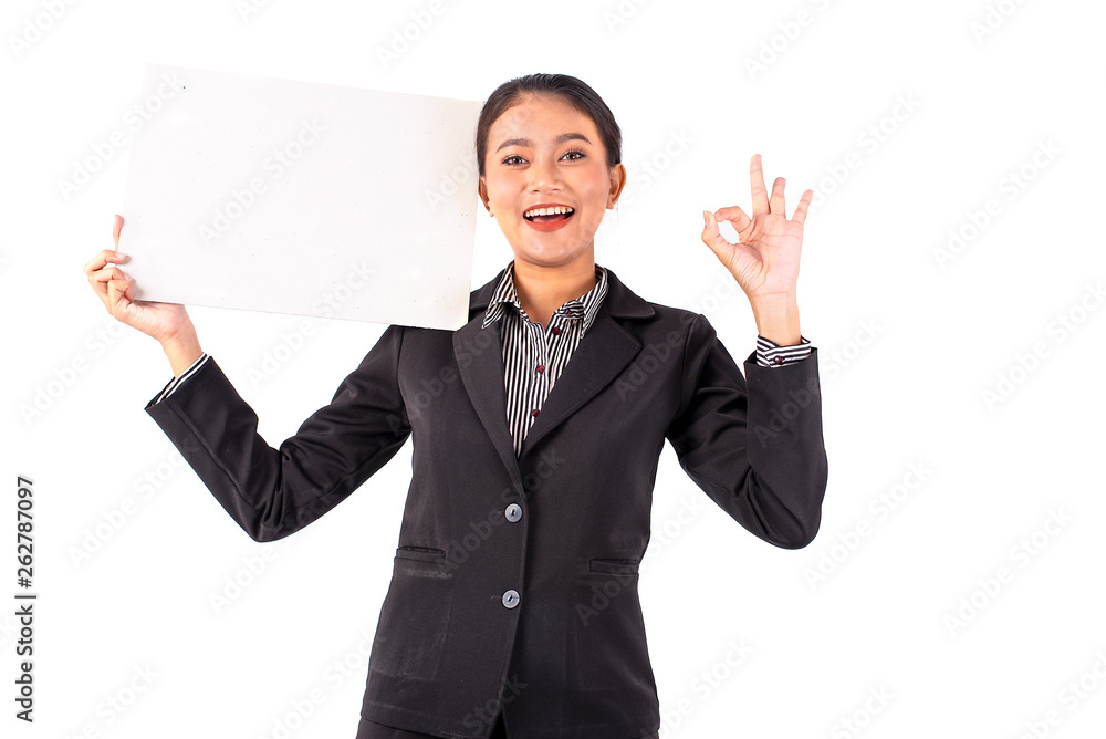Portrait isolated Southeast Asian business woman wears dark gray suit action by show OK sign with blank white board or paper on white background and show feeling happy and cheerful Portrait isolated Southeast Asian business woman wears dark gray suit action by show OK sign with blank white board or paper on white background and show feeling happy and cheerful
