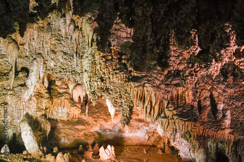 The beautiful stalactites and stalagmites and other rock formations are reflected in a small lake in the Antro del Monte Corchia cave in the Apuan Alps in Italy. photo