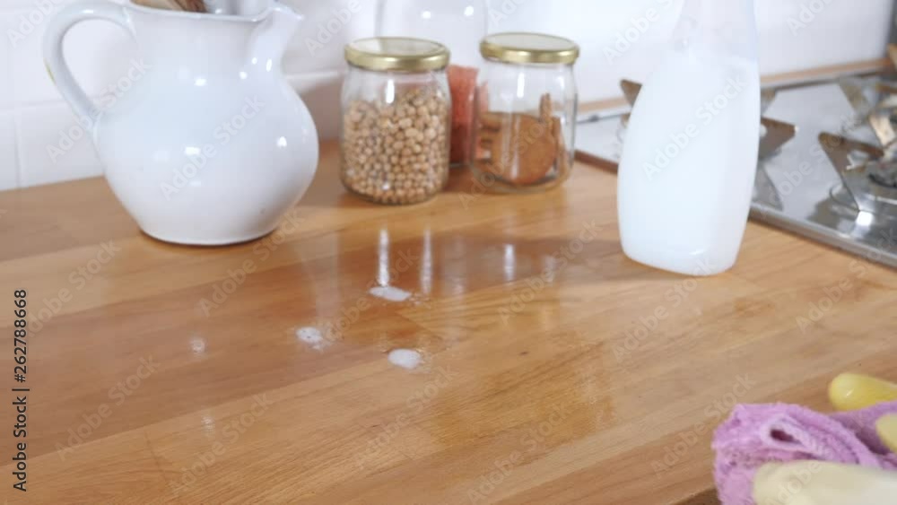 House work : cleaning kitchen top with spray detergent and sponge House work : cleaning kitchen top with spray detergent and sponge