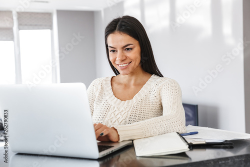 Attractive young woman working with laptop computer