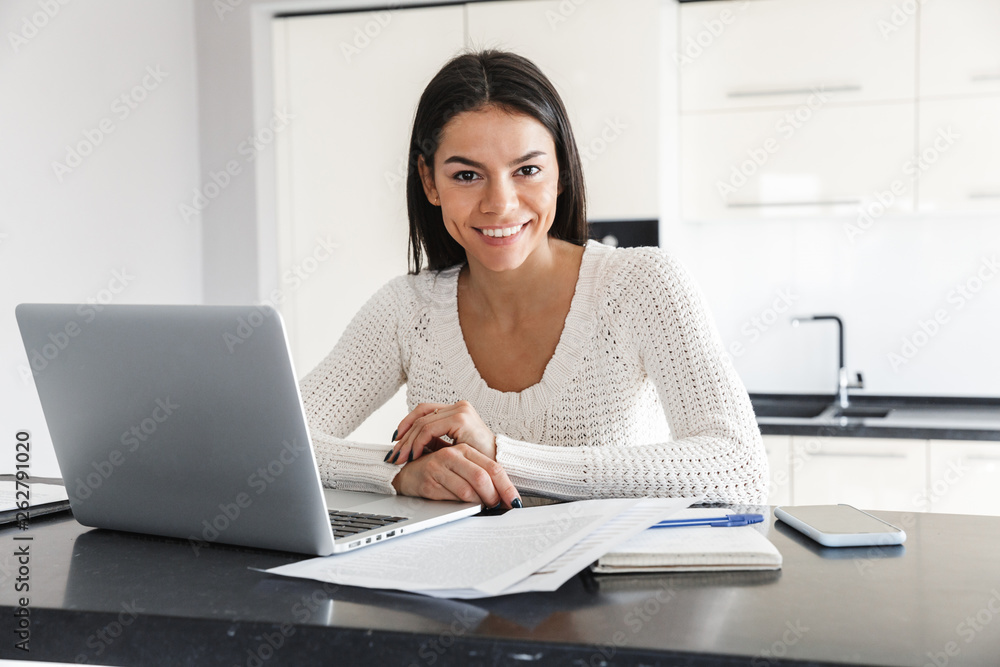 Attractive young woman working with laptop computer Attractive young woman working with laptop computer