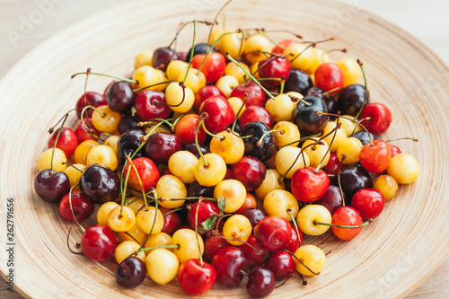 Image of fresh ripe cherries on bowl. White and red cherries. Healthy eating. Seasoanl fruits. Nutrition concet. Raw food