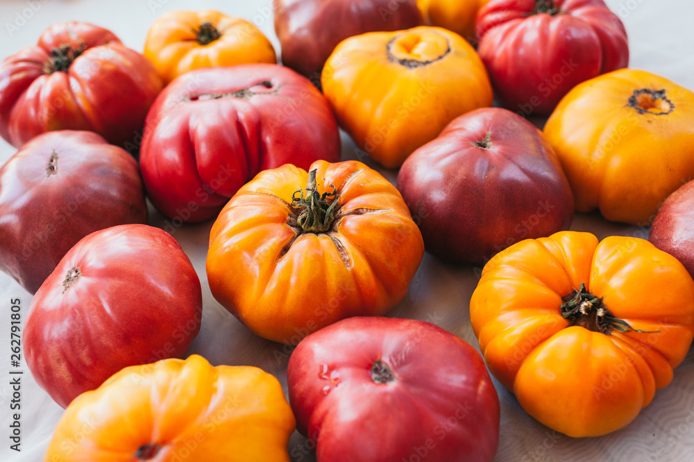 Flat lay of fresh yellow and red reipened heirloom tomatoes on white background. Fresh vegetables. Healthy nutrition concept. Organic food Flat lay of fresh yellow and red reipened heirloom tomatoes on white background. Fresh vegetables. Healthy nutrition concept. Organic food