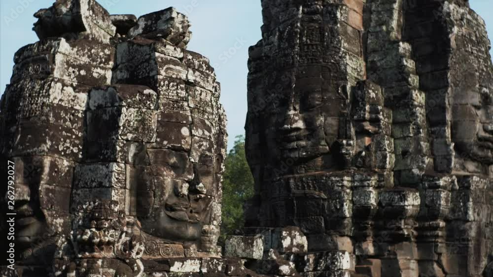 Sliding view of enormous stone face-towers depicting Avalokitesvara, a bodhisattva who embodies the compassion of all Buddhas. Bayon Temple, Cambodia Sliding view of enormous stone face-towers depicting Avalokitesvara, a bodhisattva who embodies the compassion of all Buddhas. Bayon Temple, Cambodia