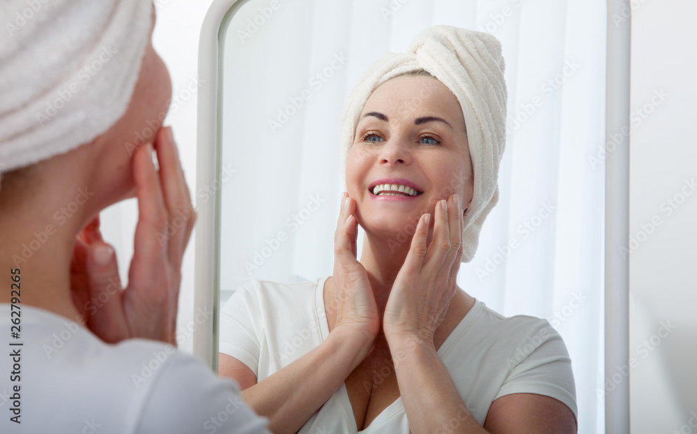Forty years old woman looking at wrinkles in mirror. Plastic surgery and collagen injections. Makeup. Macro face. Selective focus on the face. Forty years old woman looking at wrinkles in mirror. Plastic surgery and collagen injections. Makeup. Macro face. Selective focus on the face.