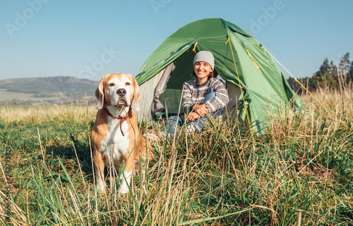 Photography Woman with her pet beagle dog rest in camping tent