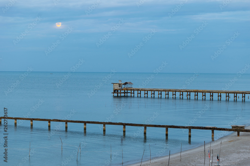 Beach, Bridge and The moon is rising at .Nim Seng Beach, Songkhla, Thailand.