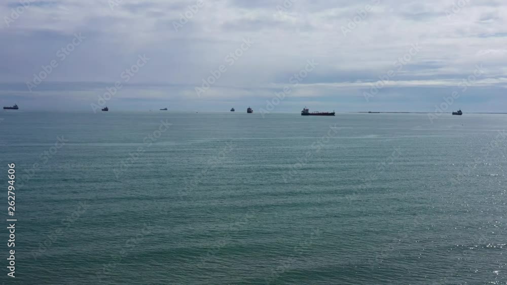Mediterranean sea with oil tankers in background cloudy day aerial shot