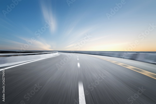 Motion-blurred highway in dusk clouds