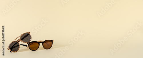 Sunglasses sale concept. Wooden sunglasses on yellow background. Copy space for text. For banner optic shop