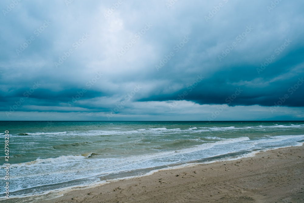 Windy storm beach seashore seaside sea waves dark clouds