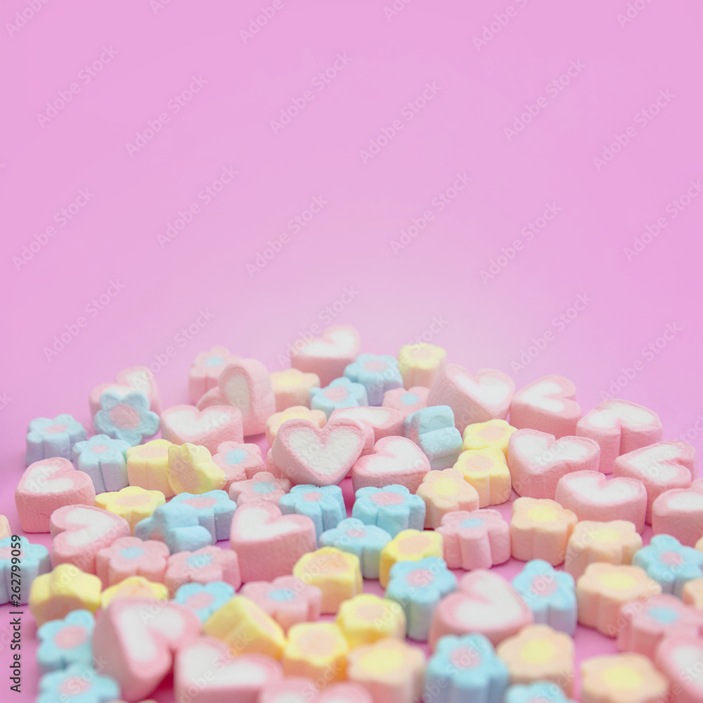 Selective focus of sweet pastel color of marshmallows on pink background