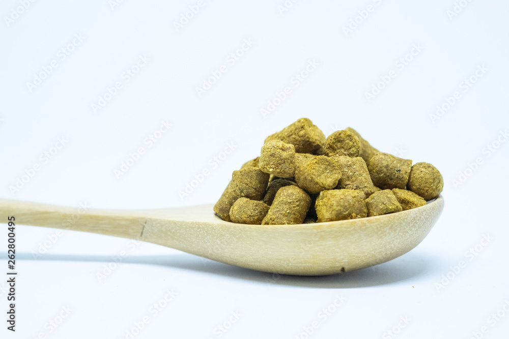 Pellets hops on a spoon wood for home brewing Isolate. Pellets hops on a spoon wood for home brewing Isolate.