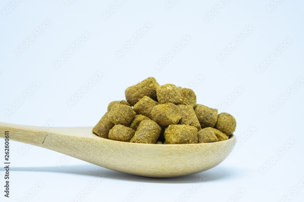 Pellets hops on a spoon wood for home brewing Isolate. Pellets hops on a spoon wood for home brewing Isolate.