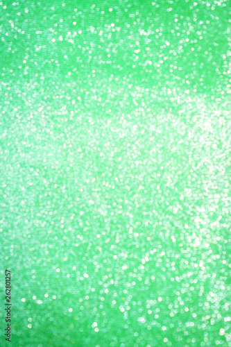 Blurred bokeh light green party background  Christmas and New Year holidays background. Party concept. Festive holiday card bright backdrop. Defocused. Flat lay  top view  copy space.