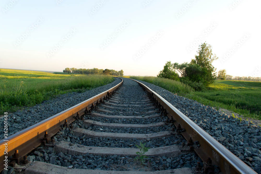 The canvas of the railway leaving far into the distance and illuminated by the setting sun The canvas of the railway leaving far into the distance and illuminated by the setting sun