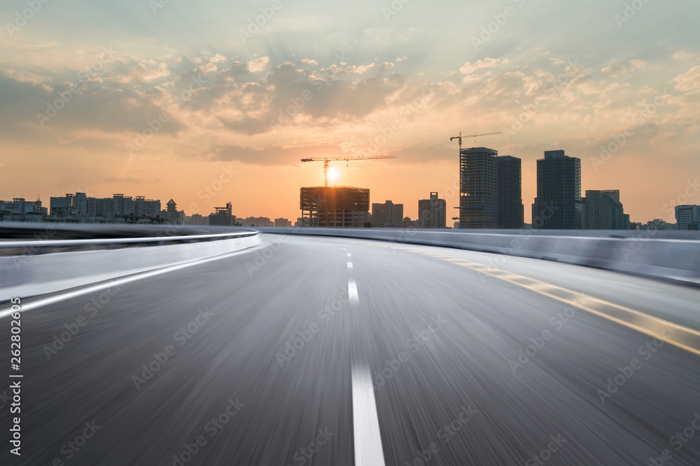 Fototapeta premium Motion-blurred highway in dusk clouds
