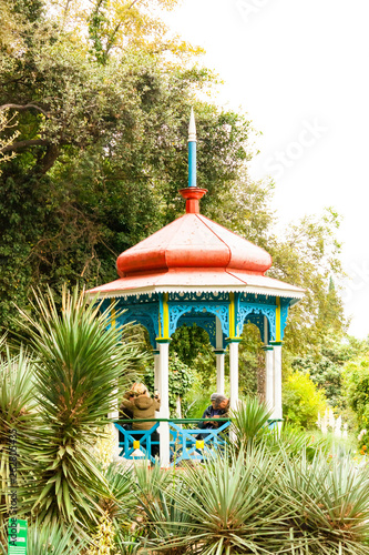 Yalta, Crimea, Russia - November 03, 2018: Nikitsky Botanical Garden pavilion gazebo in plants photo