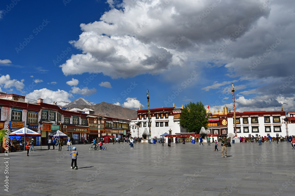 Tibet, Lhasa. People walking in the square next to the temple of Jokhang in June