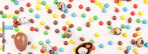 Fototapeta Naklejka Na Ścianę i Meble -  Easter frame with chocolate eggs, colorful candies
