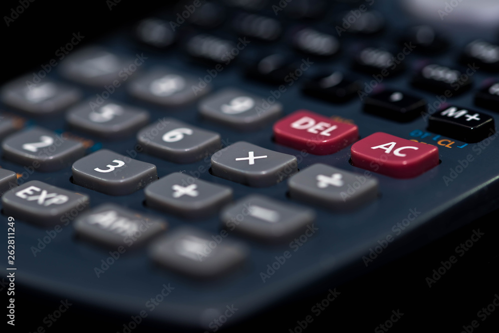 Used, dusty calculator close up macro shot on dark background. Used, dusty calculator close up macro shot on dark background.