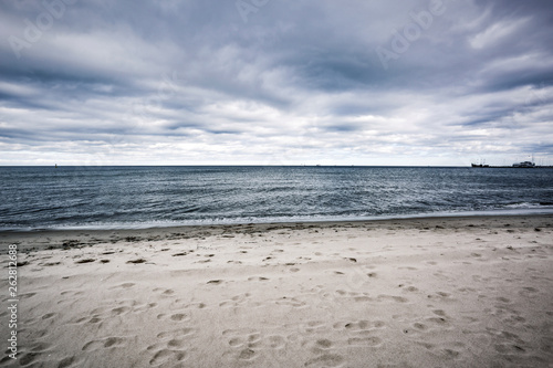 Empty beach background of free space and ocean landscape with dark sky 