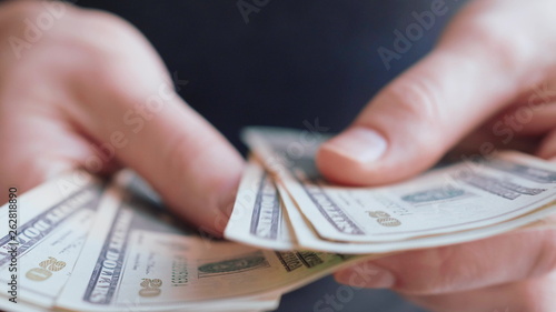 Businessman hands counting many american 20 dollars banknotes 4K close up slow mo