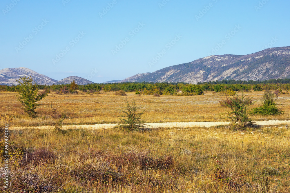 Sunny autumn day in the valley of the Dinar Alps. Bosnia and Herzegovina, Republika Srpska, Zubacko polje