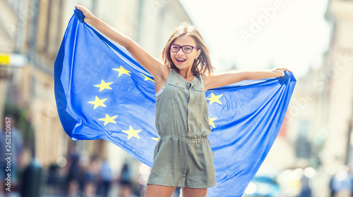 Cute happy young girl with the flag of the European Union