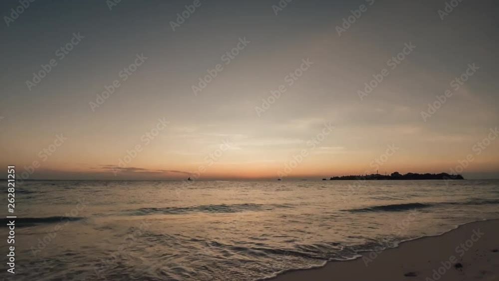 Beautiful timelapse sunset in the Maldives. In the distance, sailing boats and ships. Beautiful timelapse sunset in the Maldives. In the distance, sailing boats and ships.