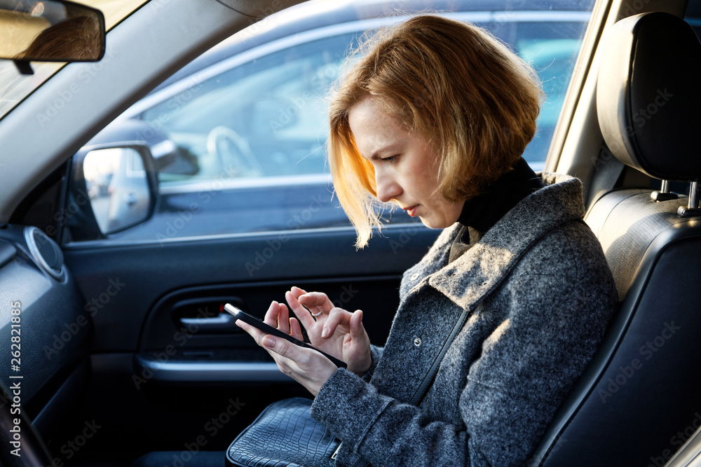 Woman Using Smartphone in Car