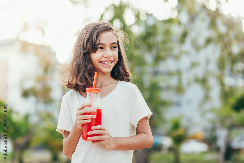Portrait of young girl drinking juice in the park Portrait of young girl drinking juice in the park