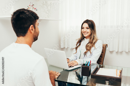 Wallpaper Mural Female sports nutritionist attending patient in her clinic Torontodigital.ca