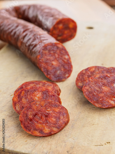 Iberian chorizo, Spanish chorizo ​​or Spanish sausage cut into slices on a wooden board