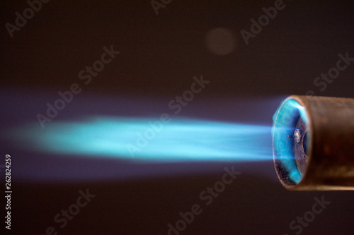 Obraz na plátne blowtorch torch burner blue flame, Industrial gas burner, against black,  close