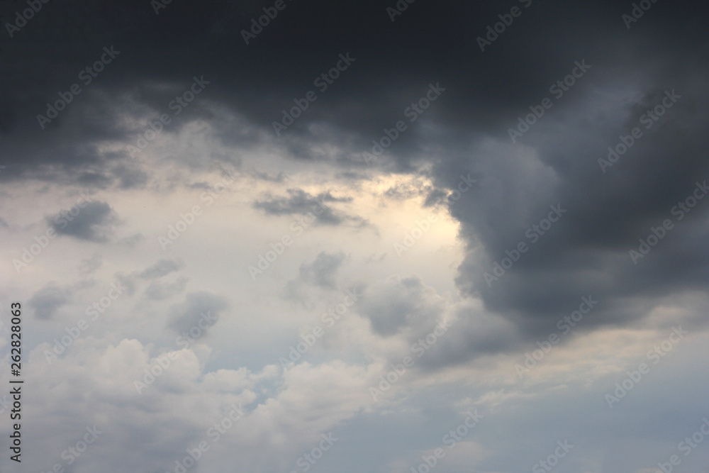 Sky with dark and light clouds and light spot