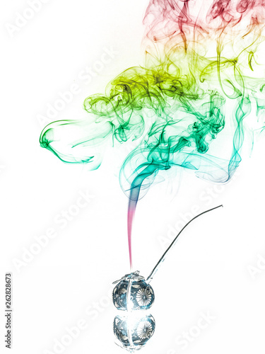 Jar with herbs emitting smoke photo